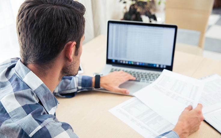 photograph of man on laptop